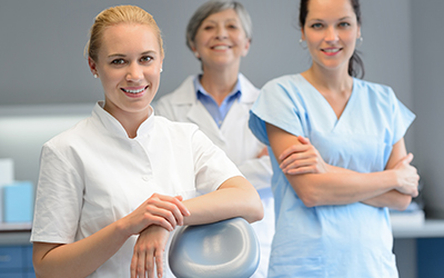 A group of three doctors smiling together